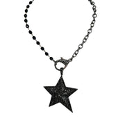 Bold gunmetal starburst pendant with pavé accents on clasp