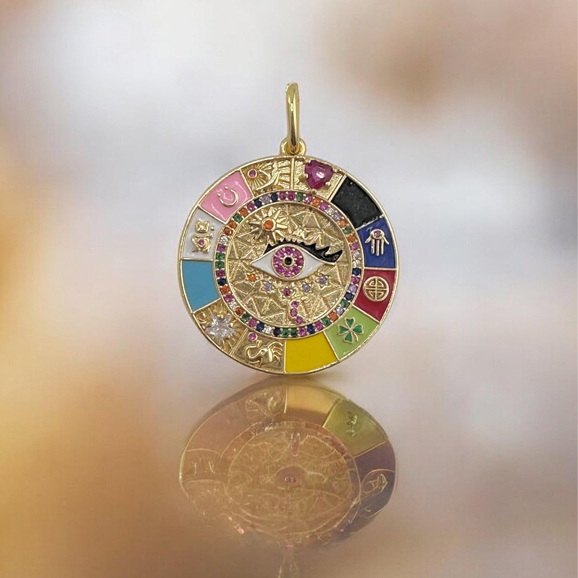 Gold enamel evil eye charm with multicolor symbols and crystals