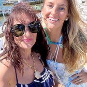 
Gold equestrian coin medallion necklace styled on model outdoors