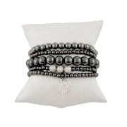 Goldie stack of gunmetal beaded bracelets and a heart charm