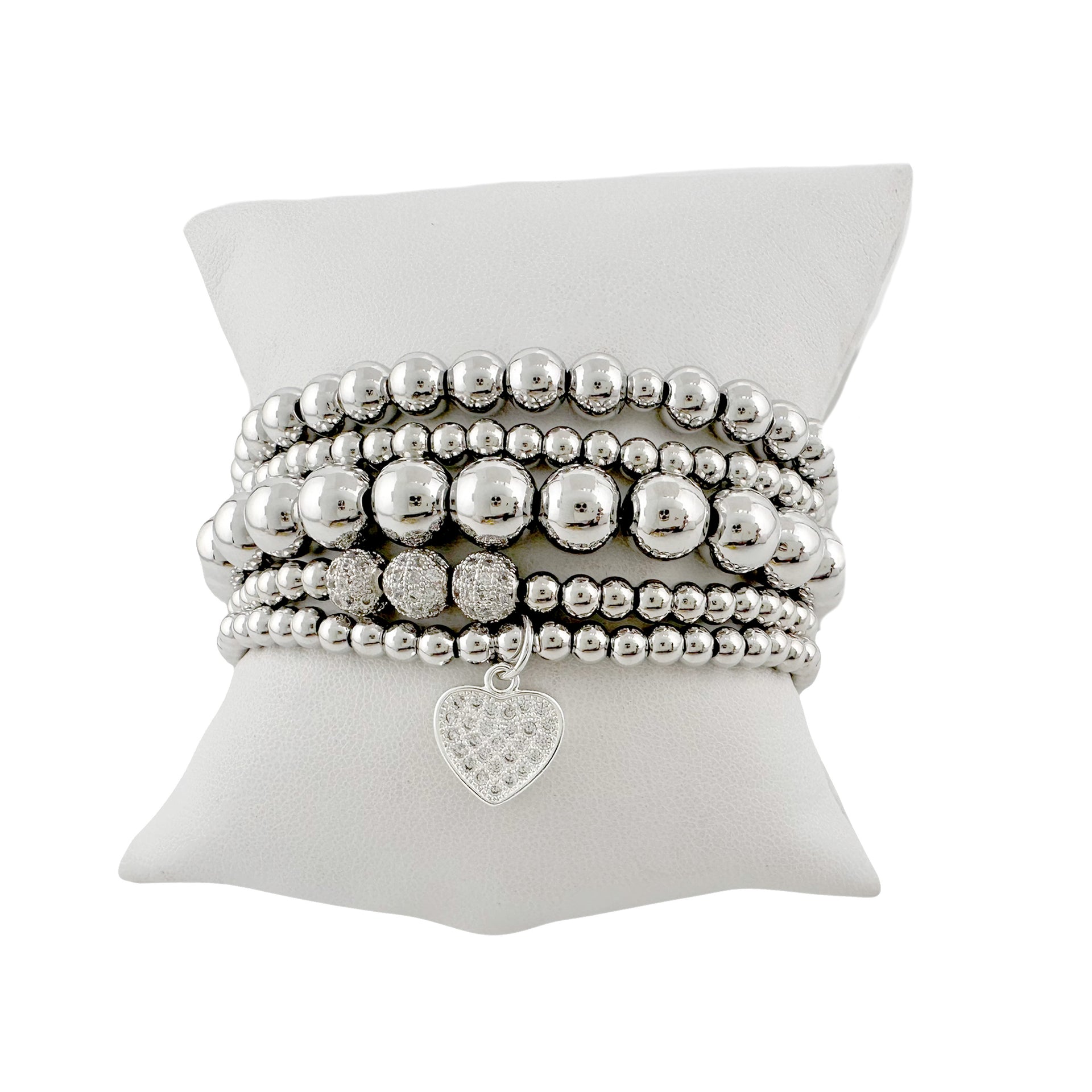 Silver stack of bracelets with a pave heart charm