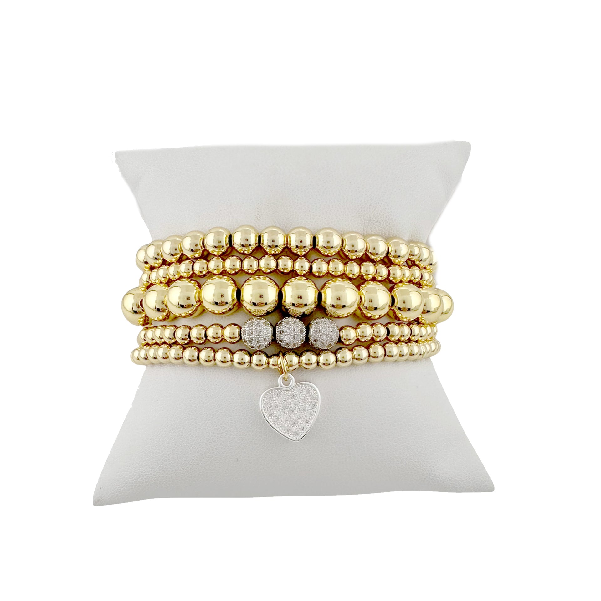 Gold stack of beaded bracelets with a heart charm 