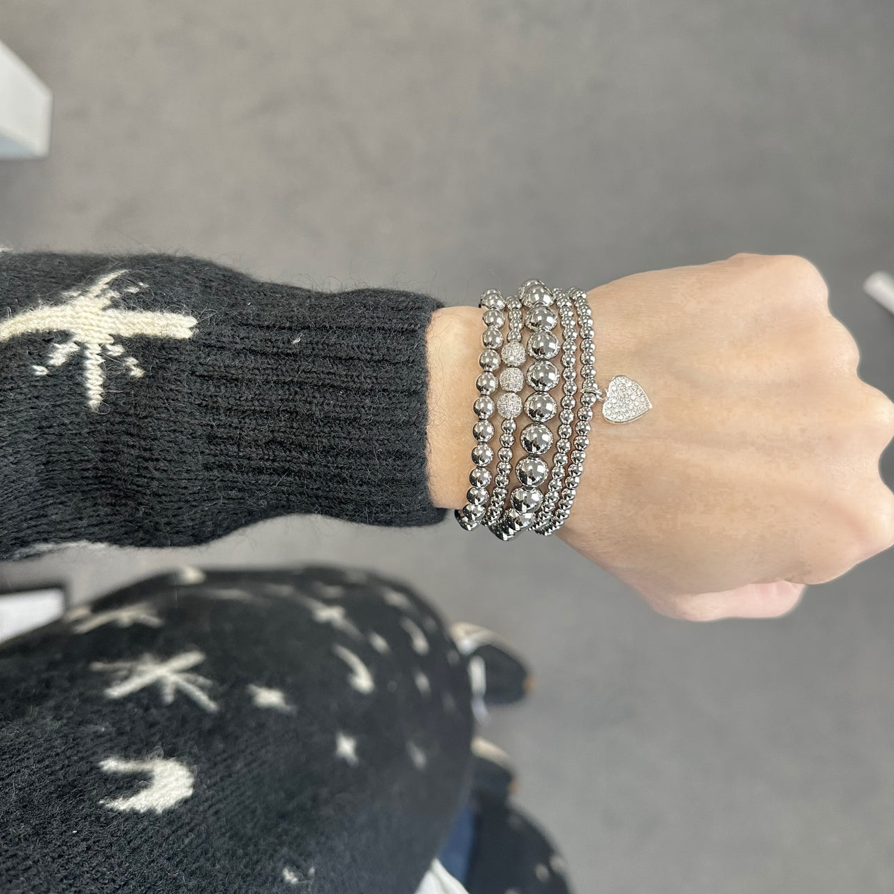 Silver goldie bracelet stack on a wrist