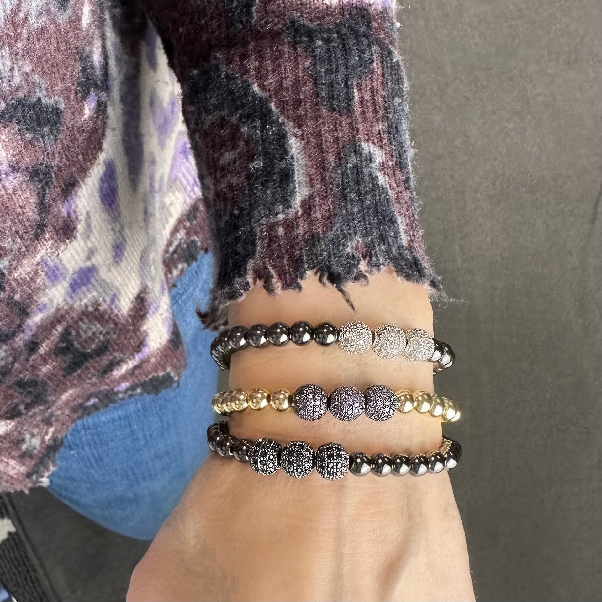 woman wearing gold beaded bracelet with silver pave beads