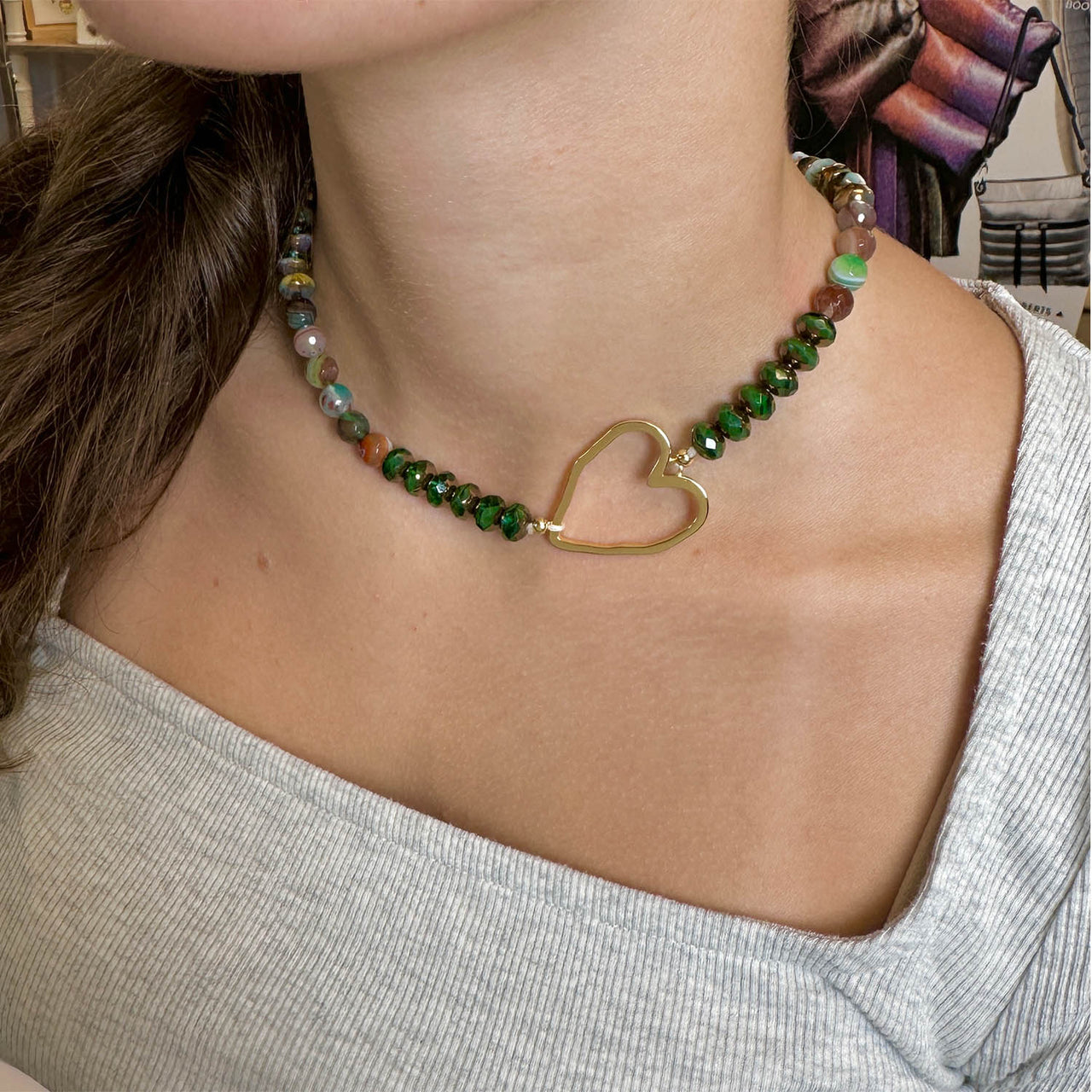 Necklace with a heart-shaped clasp worn by a person