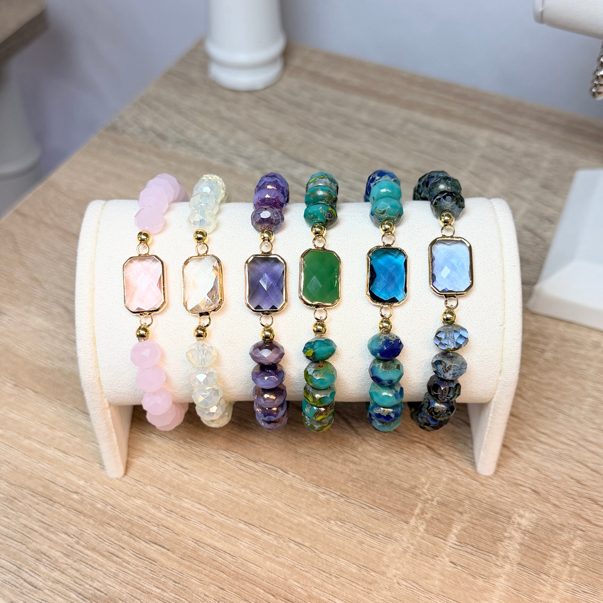 Love Lisa Hailey crystal beaded stretch bracelet with faceted crystal beads and rectangular gold framed center stone shown all colors on display