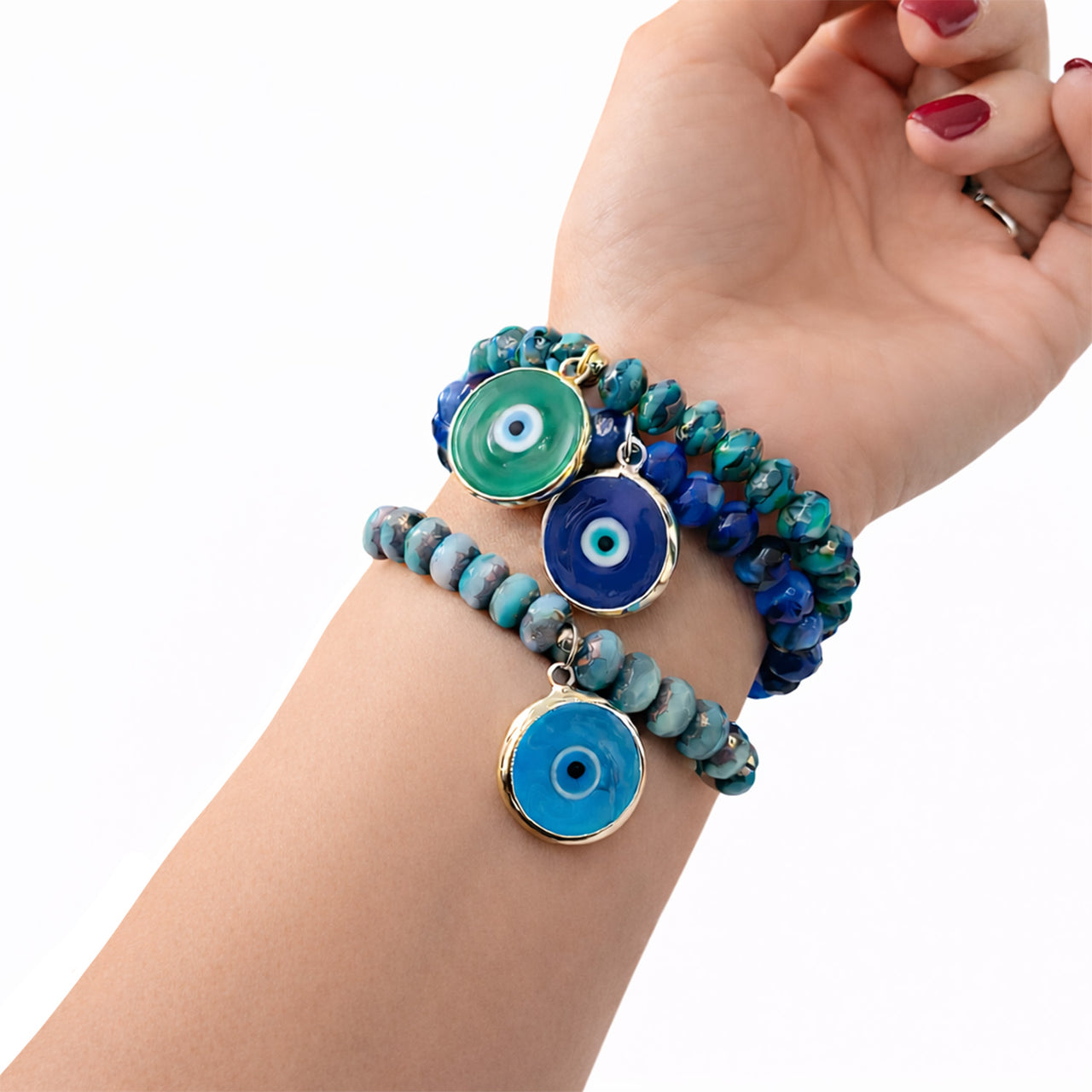 Model wearing stacked Murano glass evil eye bracelets