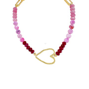 A beaded choker necklace with a gold heart-shaped pendant, featuring a mix of pink and red crystal beads.