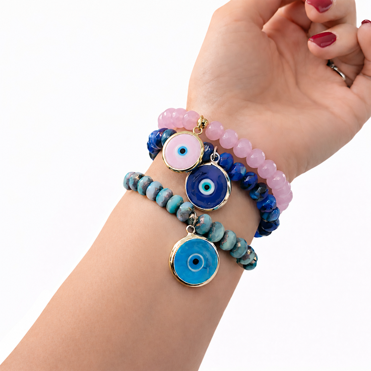 Love Lisa Hailey pink Murano Glass Evil Eye Bracelet worn in a colorful wrist stack with faceted glass beads and protective evil eye charms