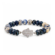Love Lisa Hamsa Mixed Gemstone Beaded Bracelet in Navy with cream and blue patterned round gemstone beads, dark navy faceted Czech glass rondelles, silver-tone accents, and a pavé CZ Hamsa centerpiece on white
