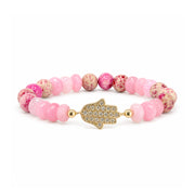 Love Lisa Hamsa Mixed Gemstone Beaded Bracelet in Pink with pale pink faceted rondelles, cream and bright pink patterned round gemstone beads, gold-tone accents, and pavé CZ Hamsa centerpiece