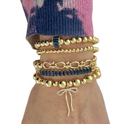 Love Lisa Hannah Blue Bonnet blue baguette and bow gold bracelet stack on wrist