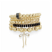 Hannah Bonnet Bracelet Stack in gold with black baguette crystals and bow charm on elastic stretch bracelets