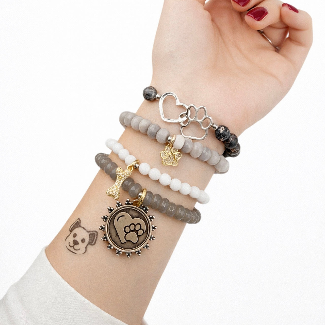 Love Lisa gemstone paw print charm bracelets stacked on wrist neutral dog lover jewelry