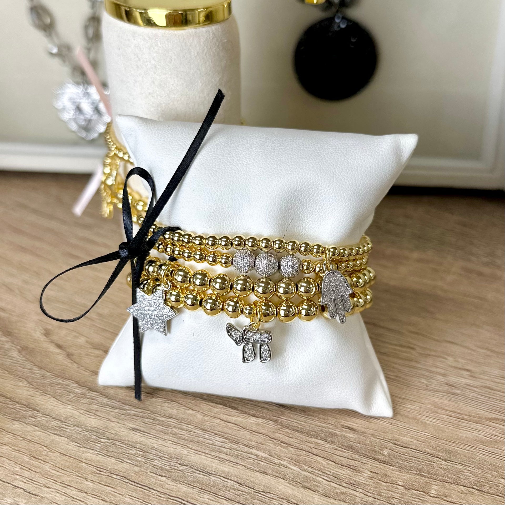 hanukkah judaica charm bracelet stack gold beaded bracelets displayed with chai hamsa and star of david charms