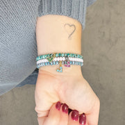 Love Lisa crystal heart charm bracelet worn on wrist layered stack
