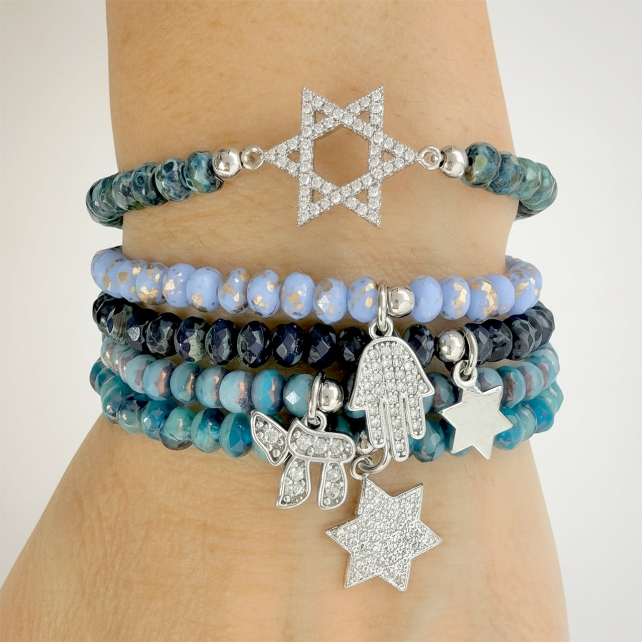 Love Lisa blue judaica bracelet stack worn on wrist chai hamsa star of david layered beaded bracelets