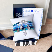 Love Lisa chai hamsa star of david bracelet stack in blue czech crystal beaded layered bracelets shown in gift box