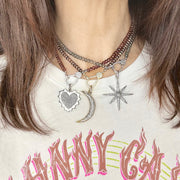 Layered on a model are three harper choker necklaces