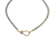 A light blue beaded necklace with a gold pave clasp.
