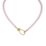 A light pink beaded necklace with a gold pave clasp.