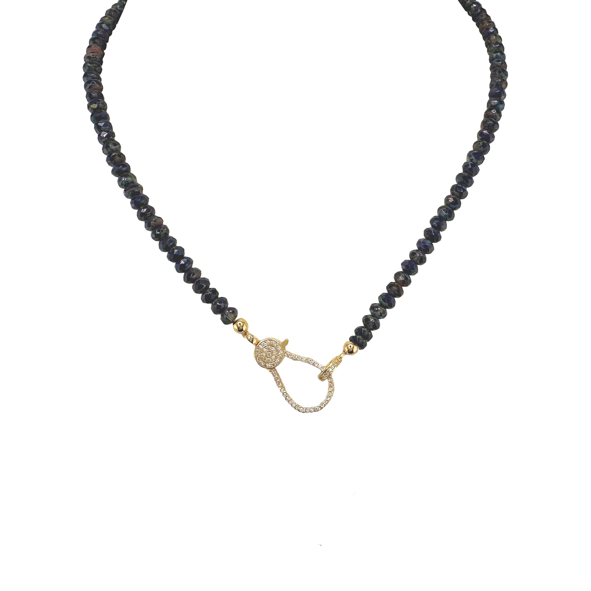 A navy blue beaded necklace with a gold pave clasp.