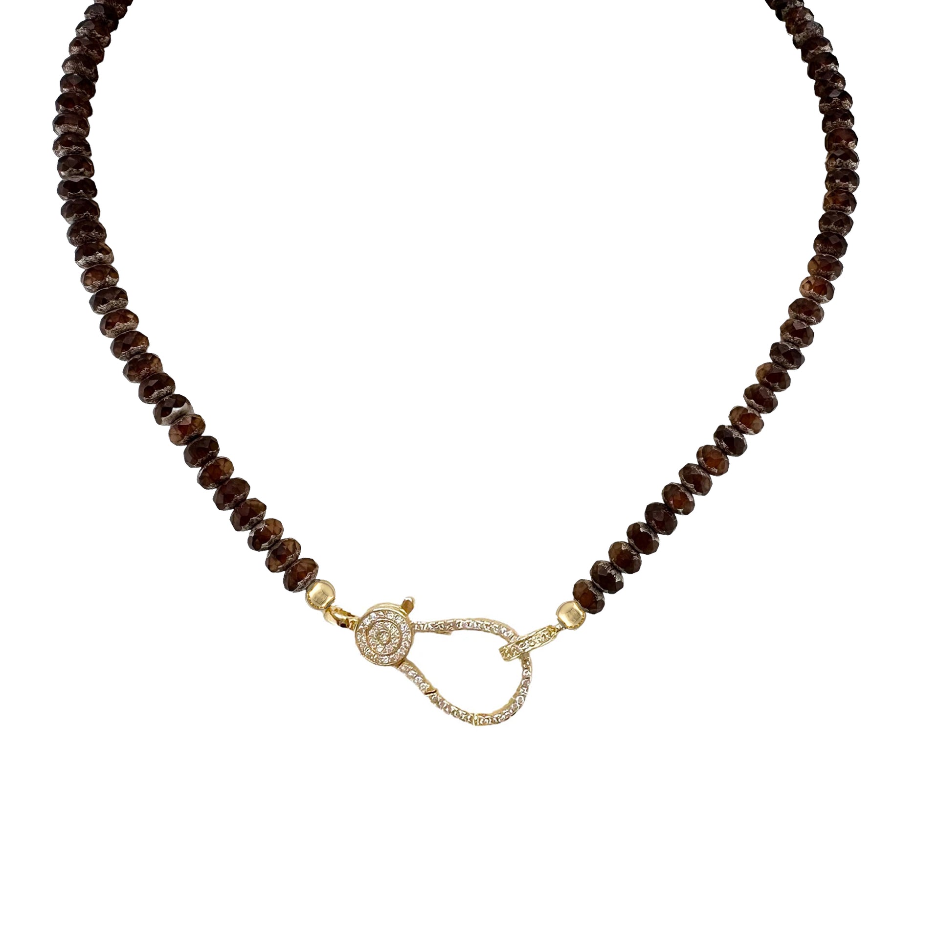 A brown beaded necklace with a gold pave clasp.