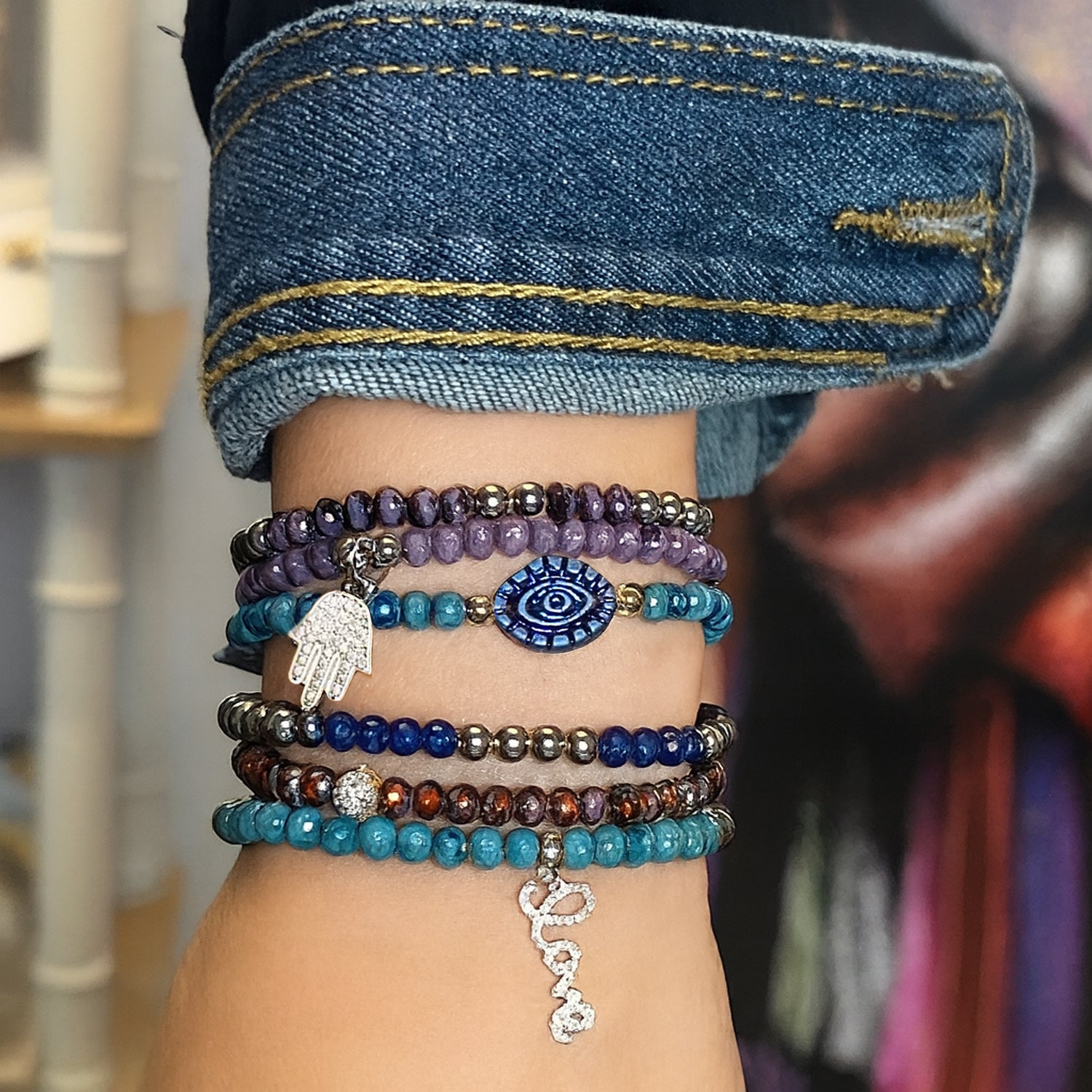 Hand wearing all the harper beaded bracelets