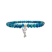 Blue beaded bracelet with a silver love charm on a white background