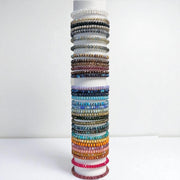 vertical tower display of harper crystal stretch bracelets stacked in assorted czech crystal colors