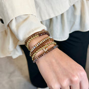 love lisa harper crystal stretch bracelets worn on wrist stacked in assorted blue and neutral crystal colors