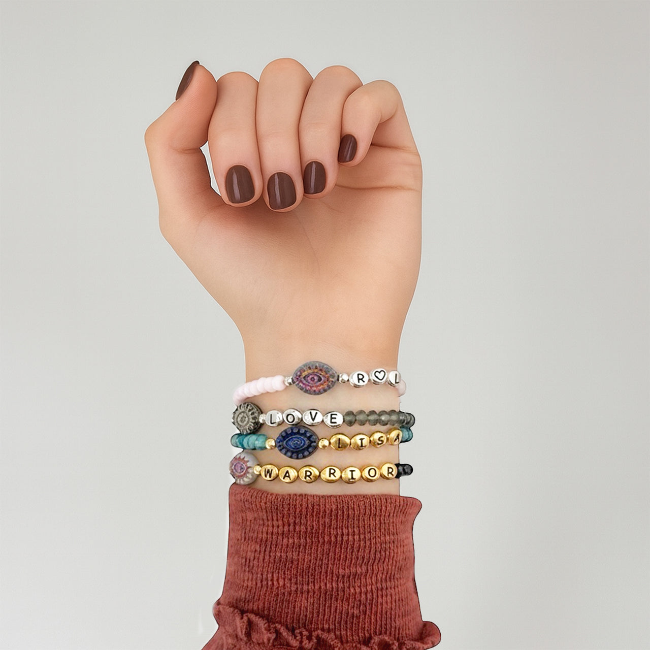 woman wearing harper evil eye bracelet stacked with other bracelets