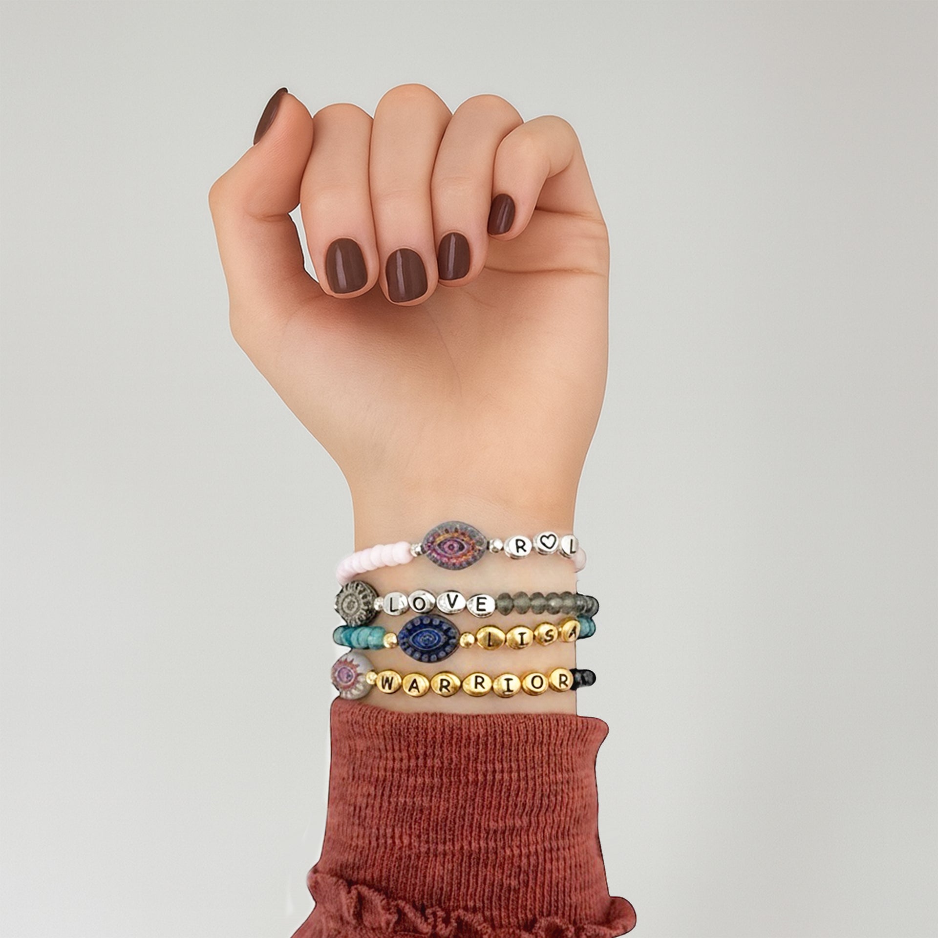 woman wearing harper evil eye bracelet stacked with other bracelets