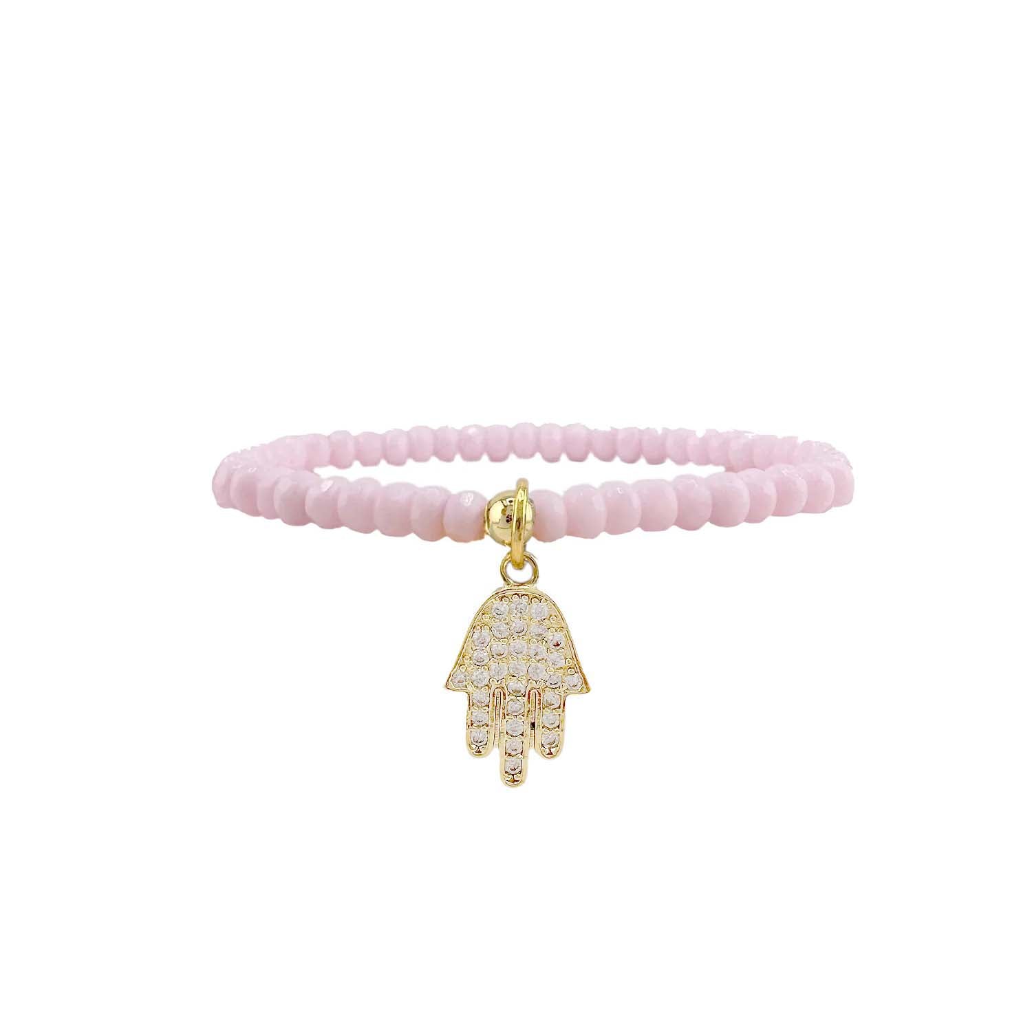 Pink beaded bracelet with a gold Hamsa charm on a white background
