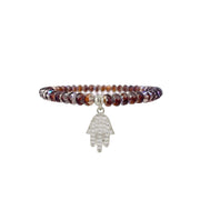 Beaded bracelet with a silver Hamsa hand charm on a white background