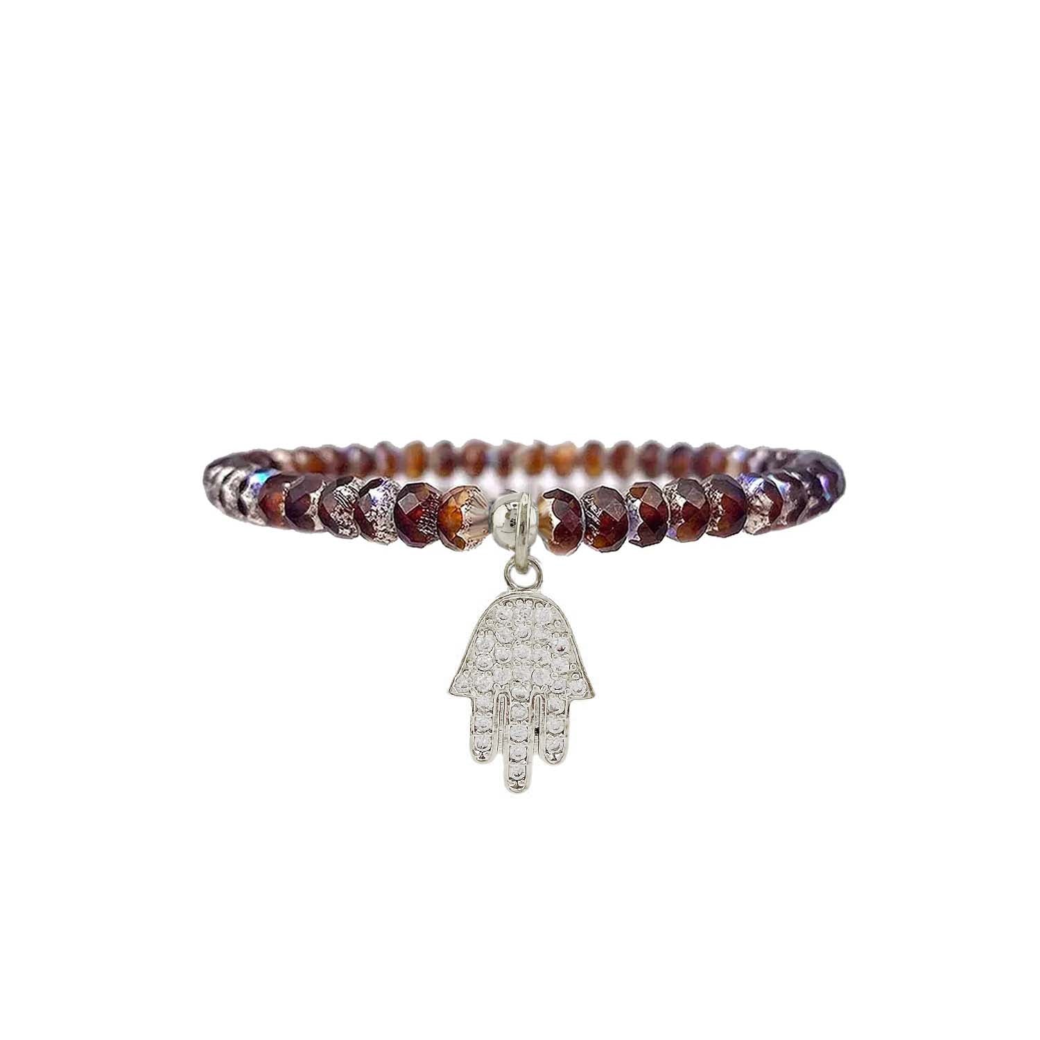 Beaded bracelet with a silver Hamsa hand charm on a white background