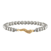 A beaded stretch bracelet featuring polished silver-tone round beads and a central wavy gold-tone clasp pavé-set with small clear stones, shown on a plain white background.