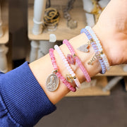 Model wearing Harper Marriage Prayer Bracelet Collection stacked for layered faith inspired bracelet look