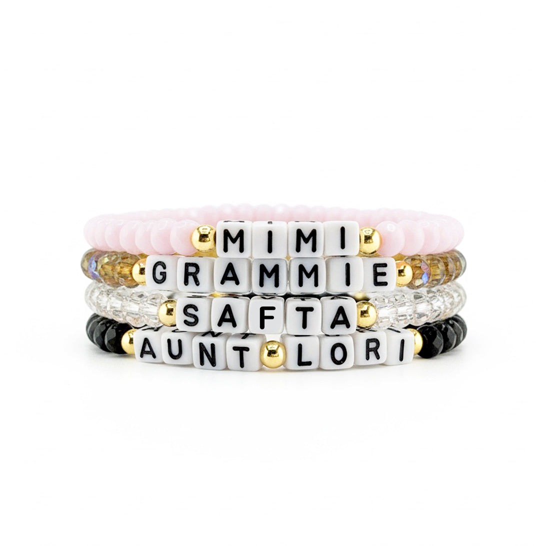 close up of stacked harper personalized word bracelets featuring czech crystal beads and custom letter beads spelling inspirational words