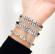 love lisa harper personalized word bracelets stacked on wrist with assorted crystal colors and custom white block letter names