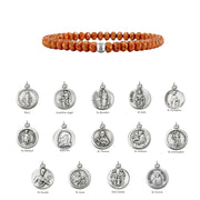 Bracelet with beaded design and silver religious medallions on a white background