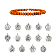 Orange beaded bracelet with silver religious medallions on a white background