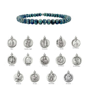 Blue beaded bracelet with silver religious medallions on a white background