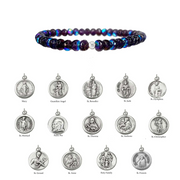 Multicolored beaded bracelet with silver religious medallions on a white background