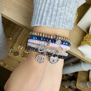 Love Lisa layered crystal bracelet stack with heart lock key and LOVE charms worn on wrist