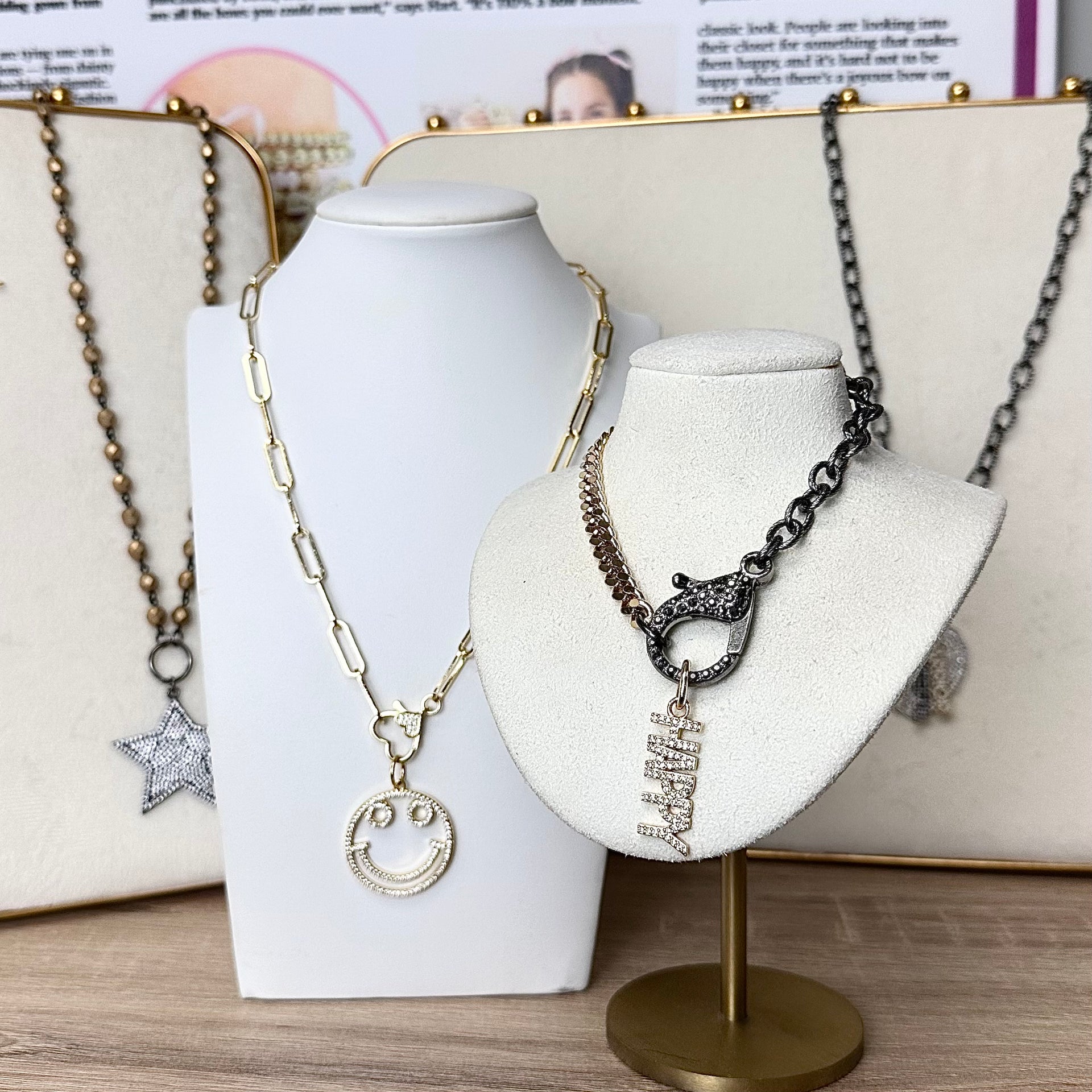 Smiley face charm displayed on jewelry stand with other pendants