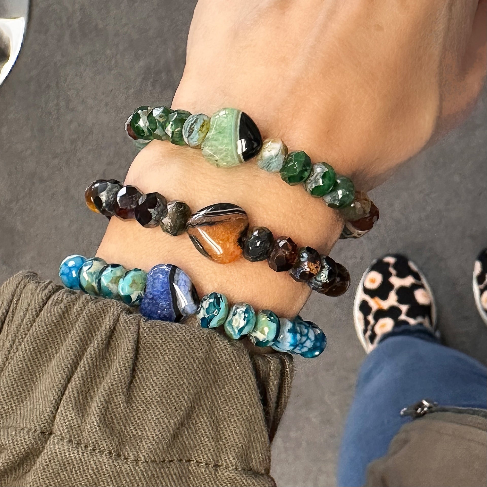 Lifestyle image of Love Lisa Heart Worry Stone Bracelet stacked with gemstone variations for mindfulness and everyday style