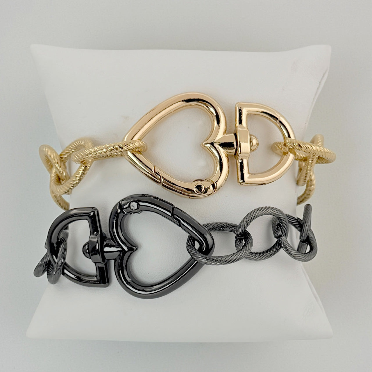 Love Lisa signature heart clasp bracelet gold chain bracelet with oversized heart clasp on display pillow
