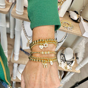 model wearing layered hebrew chai cz beaded bracelet with gold and silver beads by Love Lisa jewelry