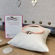 Love Lisa Hope Breast Cancer Awareness Pink Ribbon Anklet displayed on white pillow with pink ribbon charm and awareness card